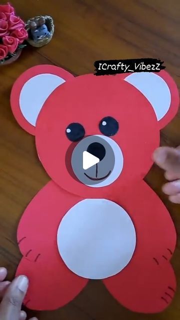 someone is making a paper cut out of a teddy bear