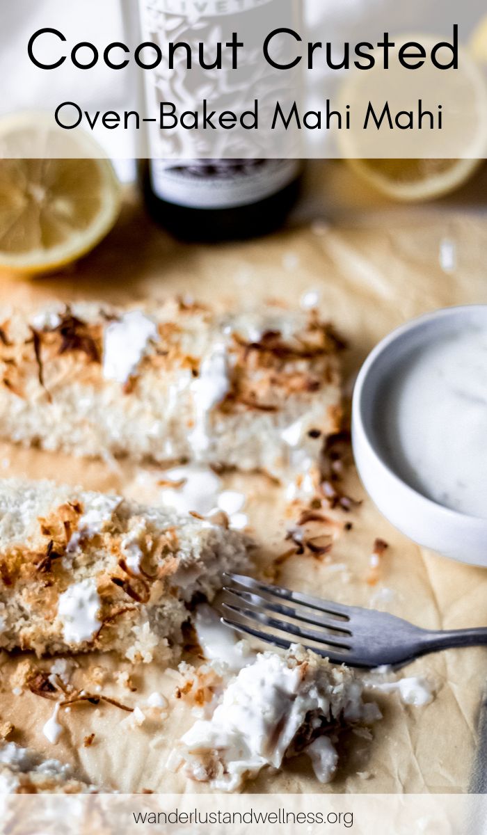 coconut crusted oven - baked mahi mahi on a cutting board with a fork