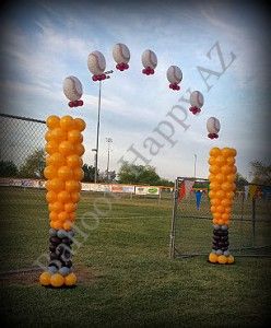 an orange and black balloon arch in the shape of baseballs on top of each other