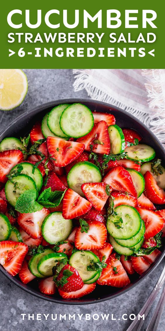 cucumber and strawberry salad with mint garnish in a bowl on a table