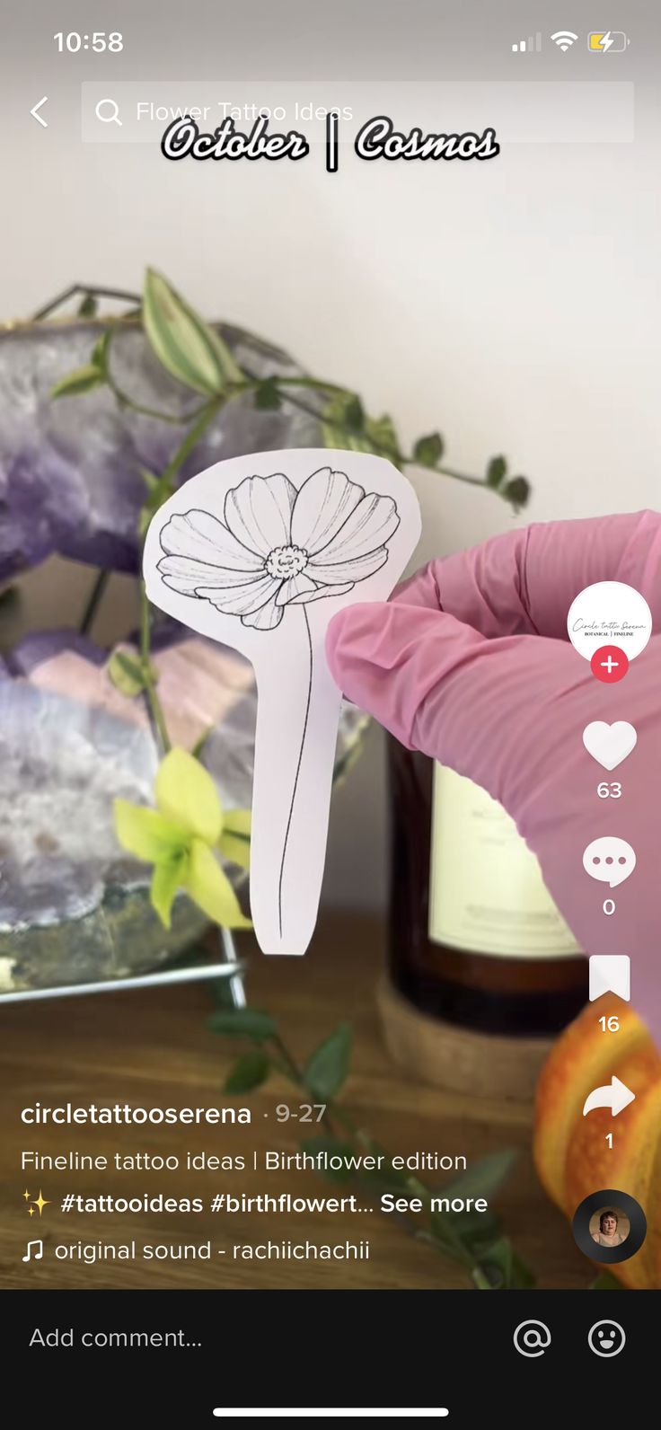 an image of someones hand holding a paper flower