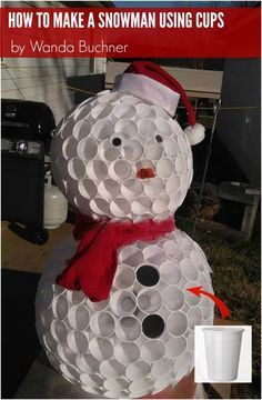 a snowman made out of toilet paper sitting on top of a wooden table in front of a house