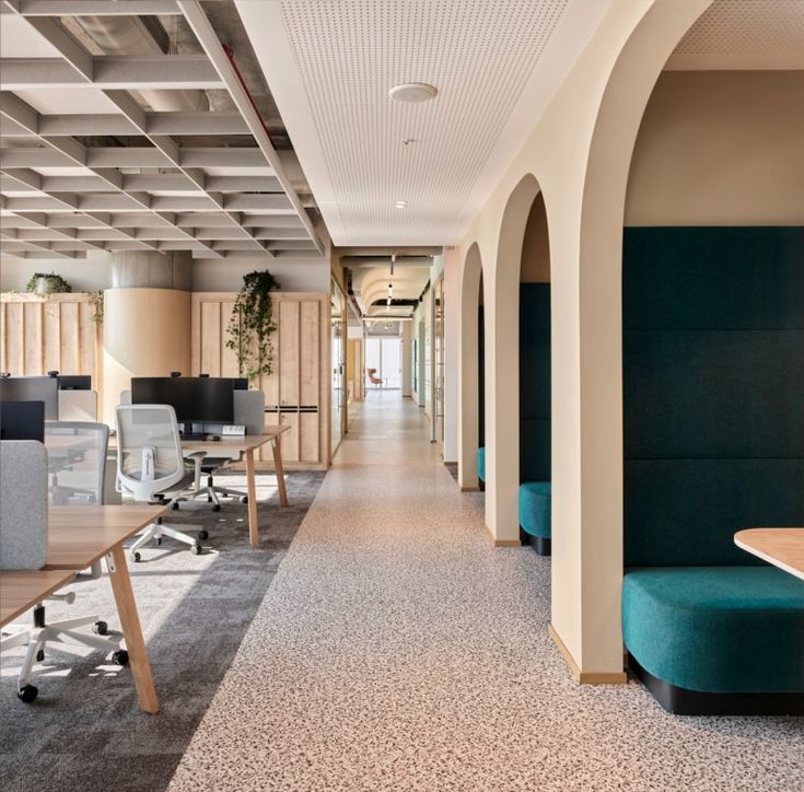 an empty office with chairs and desks on either side of the room that is lined up against the wall