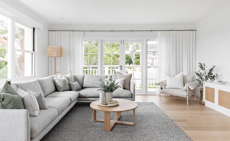 a living room filled with furniture and white walls