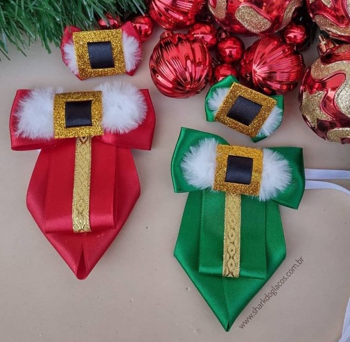 three christmas decorations are sitting on a table next to red and green ornaments with gold trim