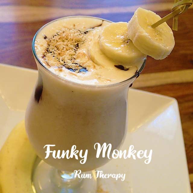 there is a drink with bananas in it on the plate and words funky monkey run therapy