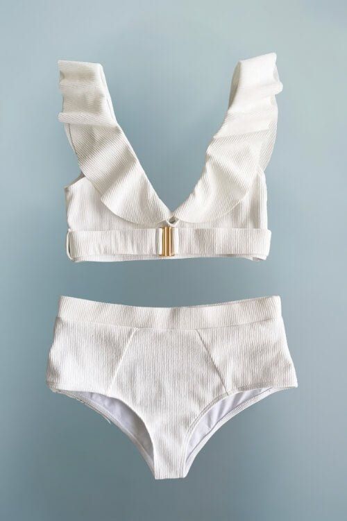 Turn up the heat this summer in our Alessandra High Waist White Bikini! This isn’t just any bikini; it’s a statement. With flirty ruffles and a sleek gold buckle detail, it’s built to party from sunrise to sunset. Whether you're chilling by the pool or rocking the beach party, this white ruffle bikini is sure to make heads turn. Chic Ruffles: Who doesn't love a little drama? The ruffled top adds a playful touch to your beach look. Glam Gold Buckle: This isn’t just a bikini; it’s your golden ticket to glam up any beach day. Flattering High Waist: High waisted bottoms mean you can snack all-day and still slay. Quality Fabric: Because we know you deserve swimwear that's as tough as you are—durable yet soft. Party-Perfect: Made for beach festivals, pool parties, and everything in between. Curvy Swim, Plus Size Mini Dresses, Plus Size Cocktail Dresses, Maxi Tops, Golden Ticket, White Bikinis, Pool Parties, Ruffled Top, Black Evening Dresses