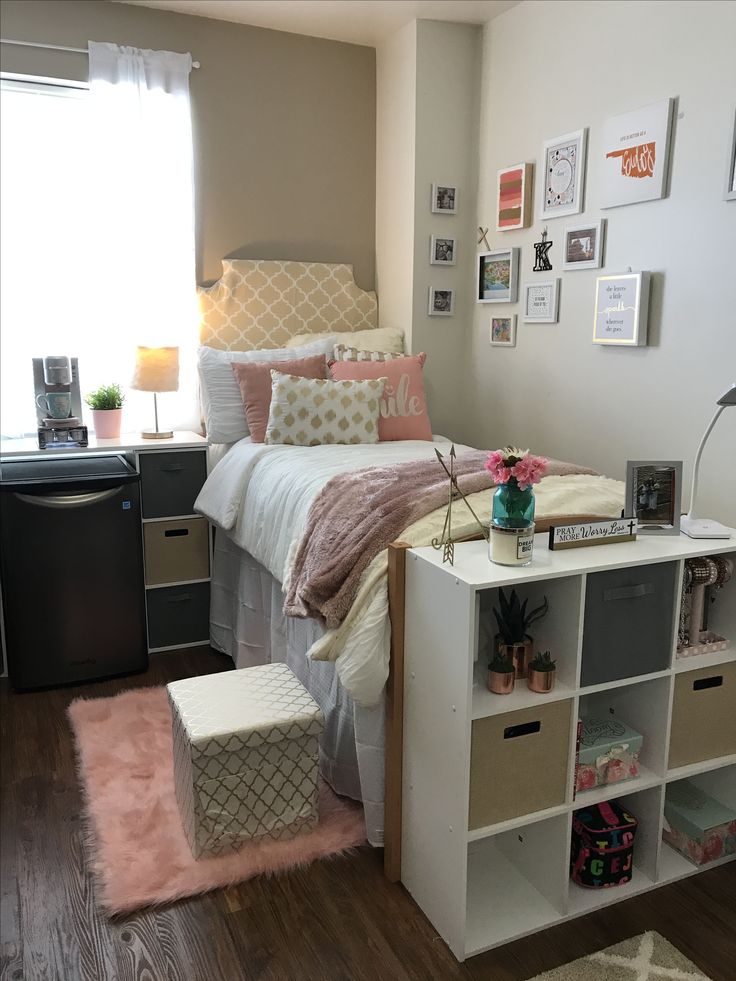 a bed room with a neatly made bed next to a desk and shelves on the wall