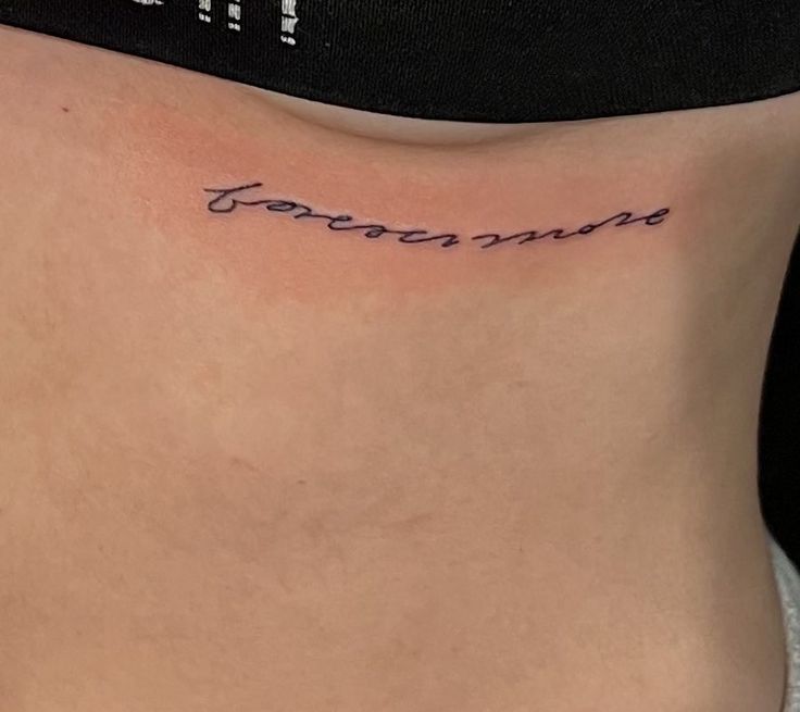 a woman's lower back with the word tomorrow tattooed on her left side ribcage