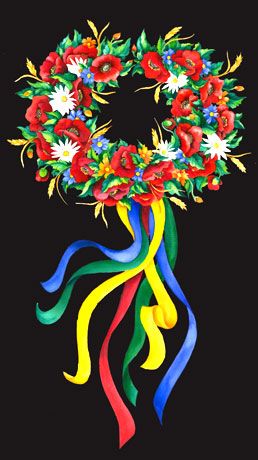 a colorful wreath with flowers and ribbons hanging from it's sides on a black background