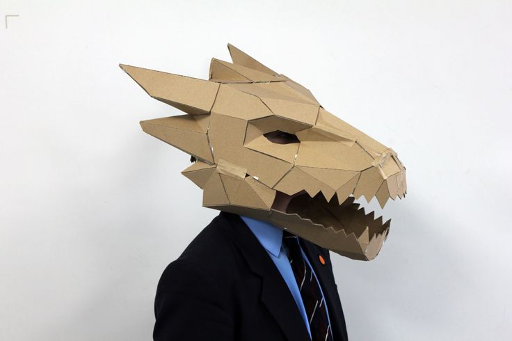 a man in a suit and tie wearing a paper mask with an animal's head on it