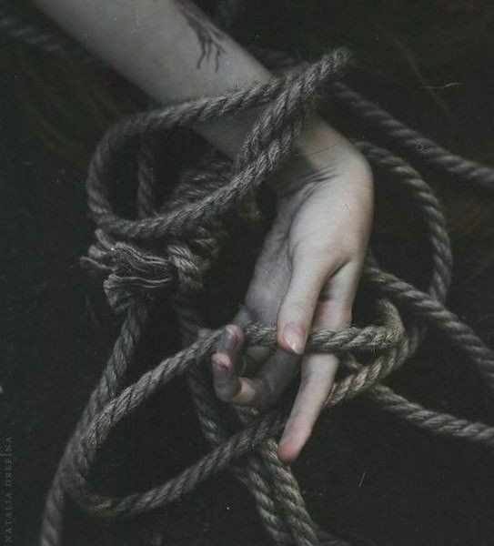 a hand tied up to a rope