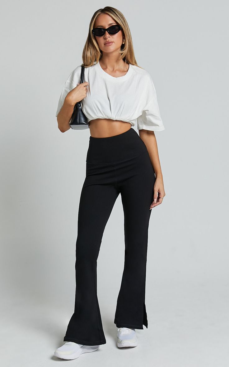 Step up your style game with our Beau Pants. These high-waisted, full-length skinny leg pants are the perfect addition to your casual wardrobe. Made from a comfortable and lightweight rayon fabric, these black pants will effortlessly elevate any outfit. The split hem adds a trendy touch while allowing for easy movement. Whether you're heading to brunch or a night out with friends, these versatile Beau Pants have got you covered. Embrace your individuality and show off your fierce fashion sense i High-waisted Elastane Pants For Loungewear, Versatile High-waisted Stretch Pants, Chic Black Elastane Yoga Pants, Stylish Black Yoga Pants, Chic Stretch Yoga Pants Straight Style, Chic Stretch Yoga Pants With Straight Cut, Chic Stretch Yoga Pants With Straight Legs, Chic Straight Yoga Pants With Elastic Waistband, High-waisted Yoga Pants With Elastic Waistband