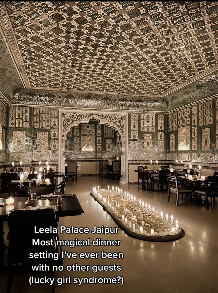 an ornately decorated dining room with candles on the table and chandeliers hanging from the ceiling