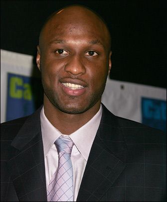 a man in a suit and tie smiling at the camera