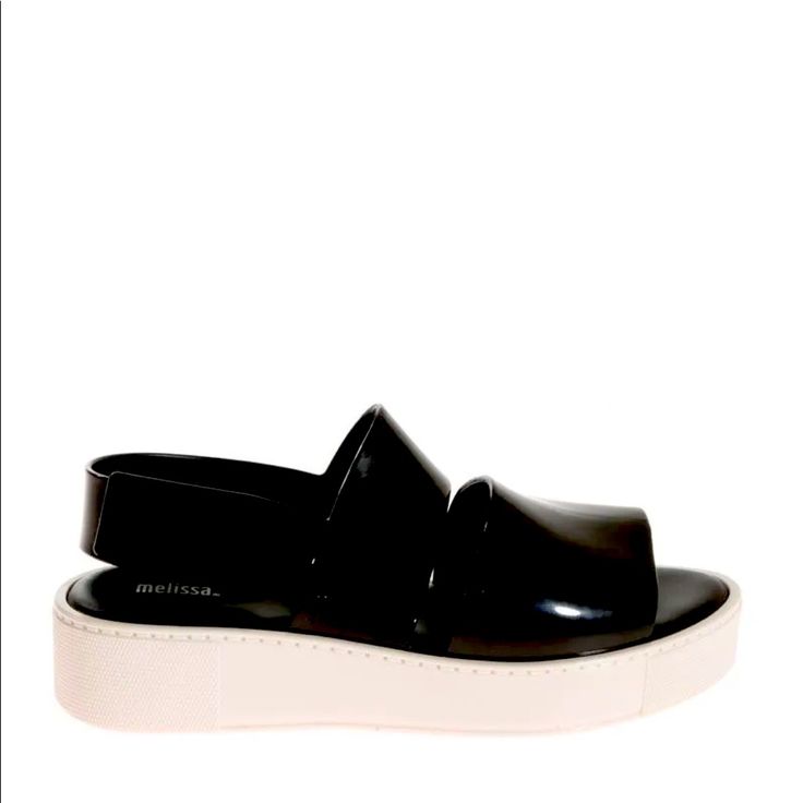 Pvc Sandals Color: Black And White Velcro Closure Rubber Sole Composition: Other Materials Exterior, Other Materials Interior, Other Materials Sole. Made In Brazil. Dimensions: Sole Height 3. 5 Cm. Modern Patent Leather Slip-on Sandals, Black Jelly Sandals With Platform And Round Toe, Black Platform Jelly Sandals With Round Toe, Black Platform Jelly Sandals In Synthetic, Black Platform Jelly Sandals In Synthetic Material, Black Platform Jelly Sandals, Black Platform Jelly Sandals For Summer, Trendy Black Patent Leather Sandals, Casual Patent Leather Sandals For Spring