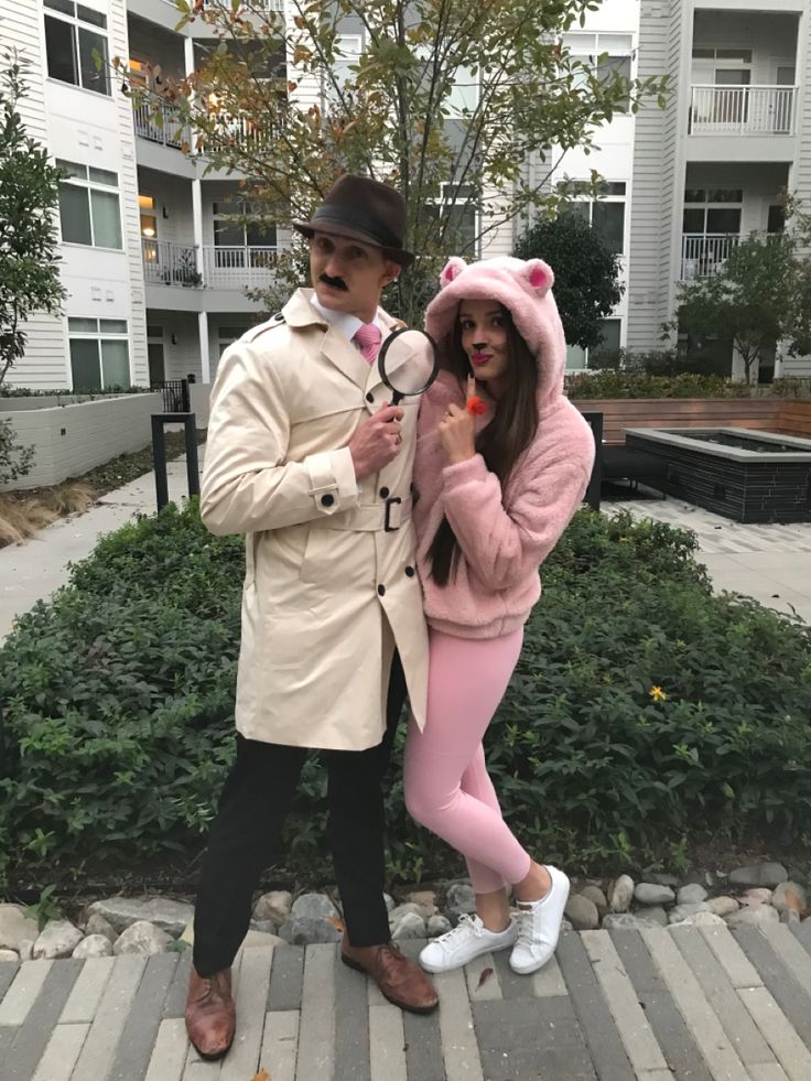 a man and woman dressed up in costumes posing for a photo outside an apartment building