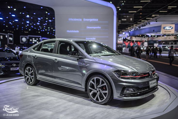 a silver volkswagen car on display at an auto show