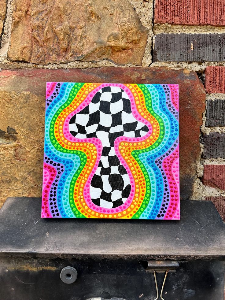 a brightly colored painting on a brick wall