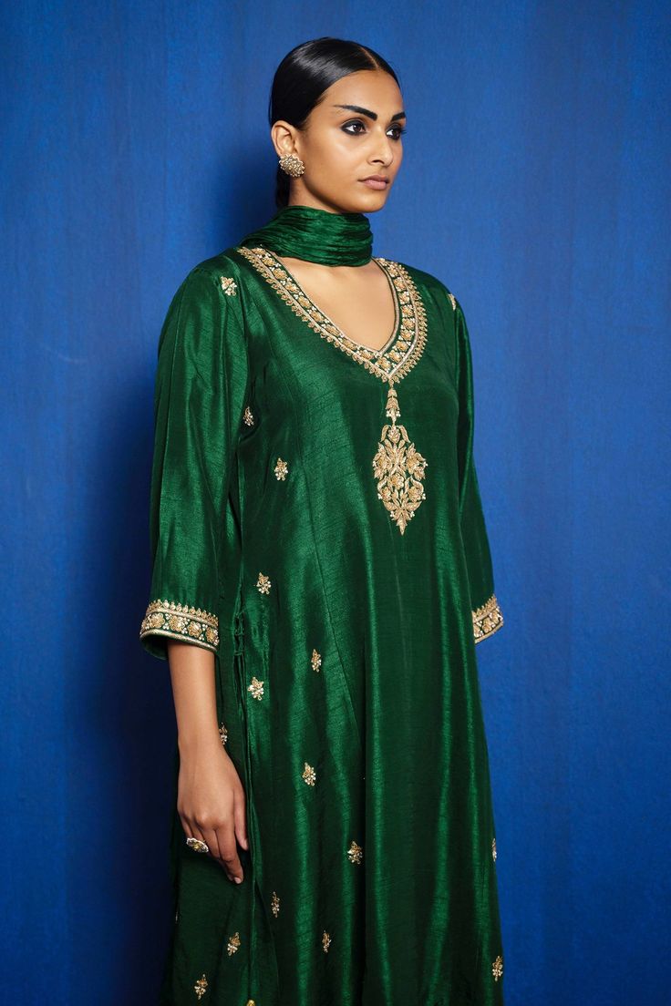 Green A-line kurta with floral zardozi hand embroidery. Comes with salwar and dupatta.
Component: 3
Pattern: Hand Embroidered
Type Of Work: Zardozi
Neckline: V-Neck
Sleeve Type: Three Quarter
Fabric: Noki Silk, Tabby Silk
Color: Green
Other Details: 
Floral pattern on kurta
Tassel hem dupatta
Occasion: Wedding - Aza Fashions V Neck Kurta, Kurta Set For Women, A Line Kurta, Suits Design, Embroidery Suits Design, Embroidery Suits, Kurta Set, Set For Women, Aza Fashion