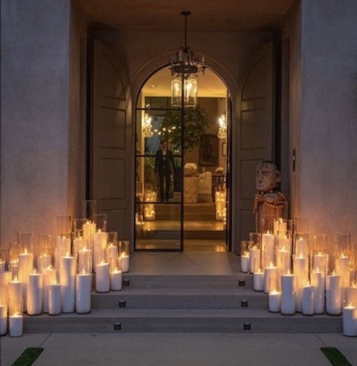 many candles are lit in front of an entrance