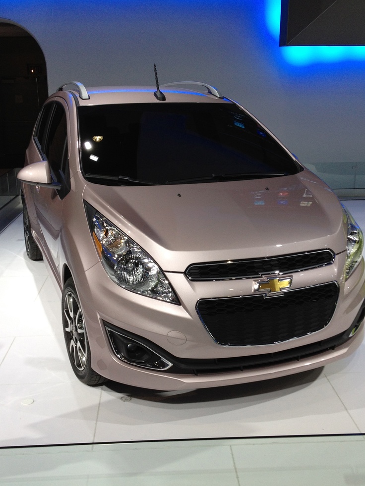 the chevrolet spark is on display at an auto show