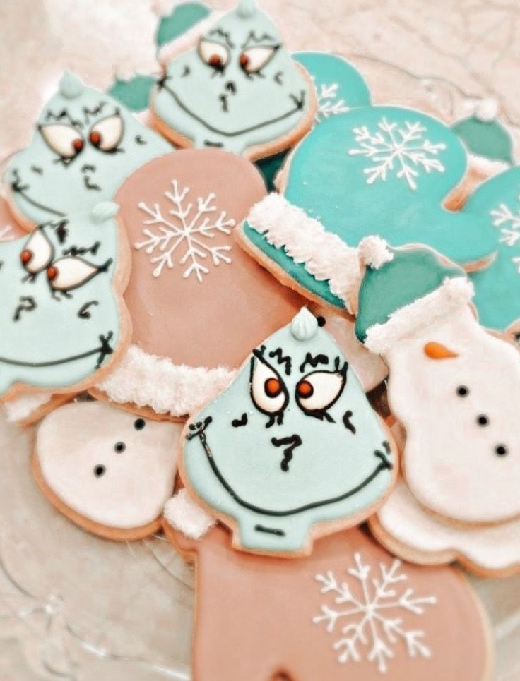 decorated cookies in the shape of santa's hats and mittens