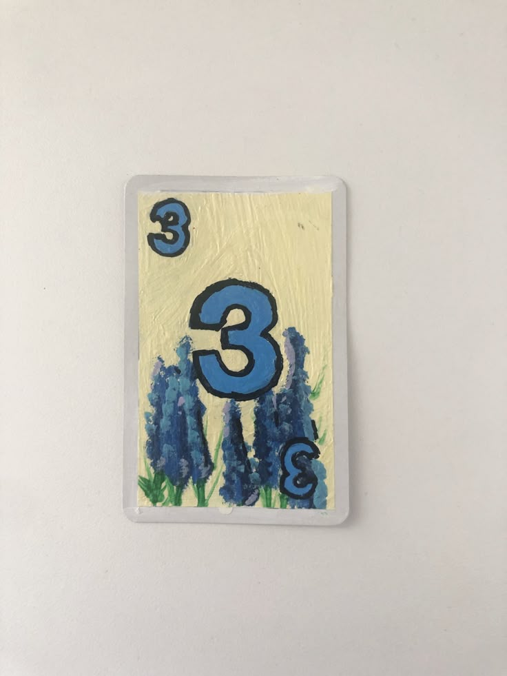 the number three is painted on a white surface