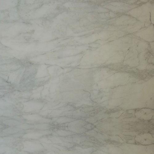 a white marble counter top with grey veining