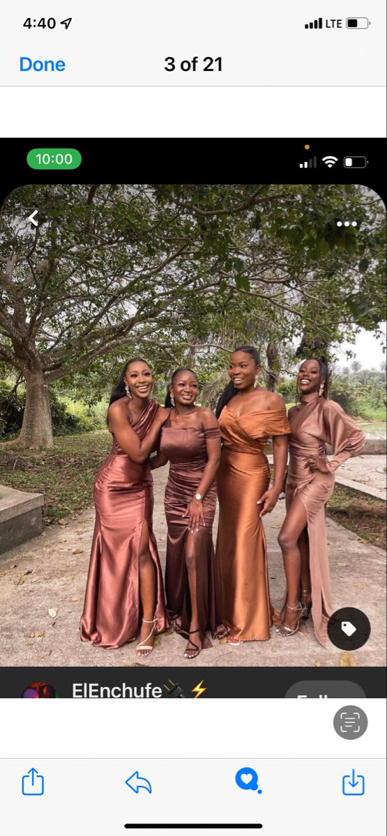 three women in long dresses posing for a photo on the same page, and one is holding