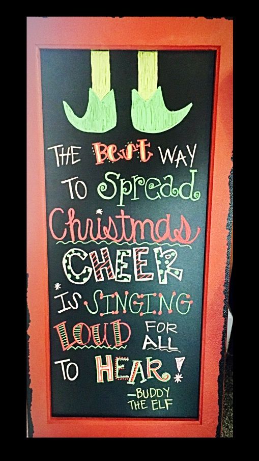 a chalk board with writing on it and two feet wearing green socks, the rest way to spread christmas cheer is singing loud