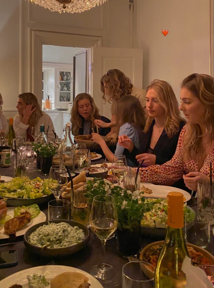 a group of people sitting around a dinner table