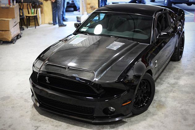 a black car is parked in a garage