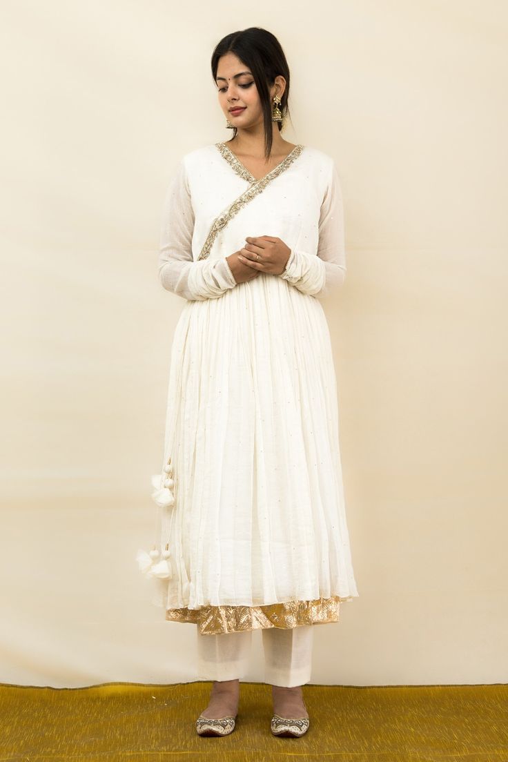 Ivory mul chanderi angrakha anarkali with pure lampi hand embroidered edges.
Components: 1
Pattern: Hand embroidered
Type Of Work: Pure lampi
Neckline: V Neck
Sleeve Type: Churidar Sleeves
Fabric: Mul chanderi, Lining : Mulmul
Color: Ivory
Other Details: 
Chinta work all over
Closure : Tie-up with tassels
Note : Pant and dupatta worn by the model are not for sale.
Disclaimer : The natural imperfection and textures in the weaves are the outcome of handloom fabrics (not to be considered as defect) V Neck Churidar, Angrakha Anarkali, Churidar Sleeves, Handloom Fabric, Fashion App, Churidar, Color Ivory, Anarkali, Aza Fashion