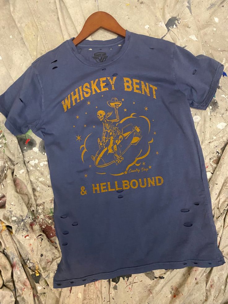 Country Deep 1970's Vintage Whiskey Bent and Hellbound unisex distressed T shirt in vintage wash black Vintage country western cowboy T shirt 40 Singles Jersey 100% Cotton Premium quality ringspun and compacted cotton Fine Cotton Jersey that is pigment dyed for a more vintage look Features tears and destroyed features at neck and on body Each piece is unique as this process is done by hand! 3.8 oz Made In USA Every garment dye item can be a slightly different shade in color since this is a laund Vintage Whiskey, Medium Fade, Distressed T Shirt, Distressed Tee, Country Western, Vintage Country, Black Vintage, Western Cowboy, Black Media