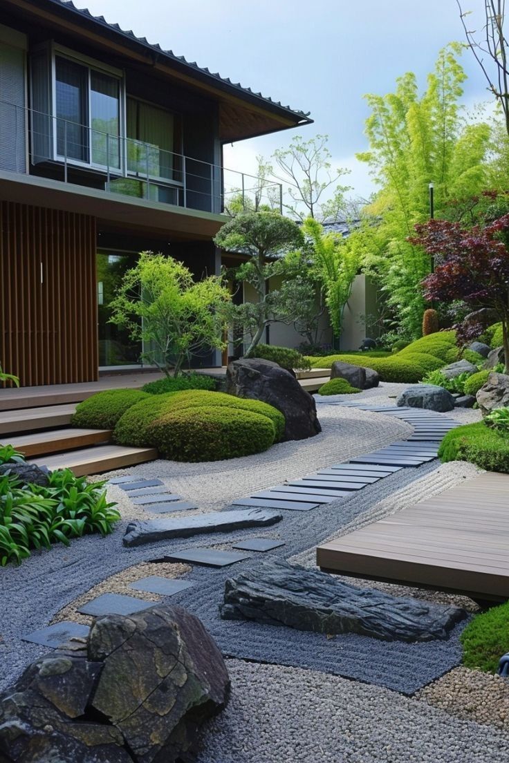 a japanese garden with rocks and plants