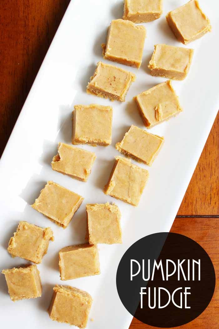 pumpkin fudge cut into cubes on a white plate with the title overlay