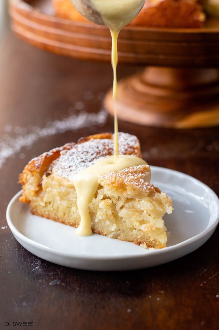 a piece of cake is being drizzled with icing on a plate