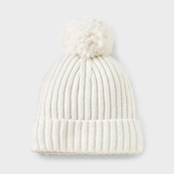 a white hat with a pom - pom on the front and bottom,