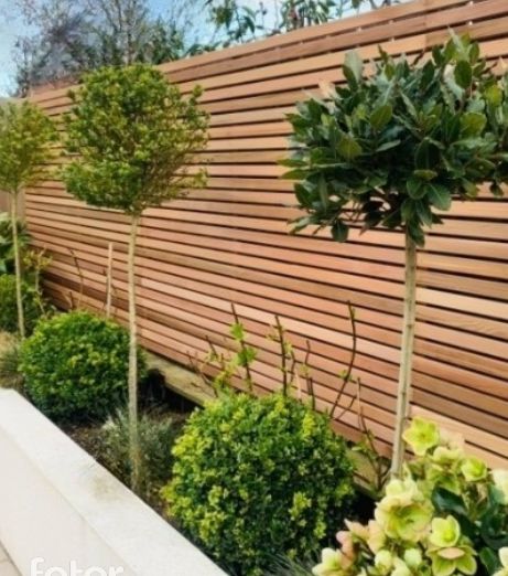 a wooden fence with some trees in it