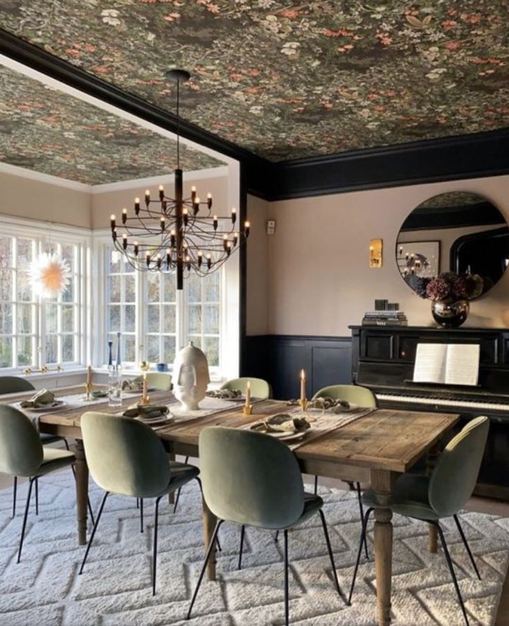 a dining room table with chairs and a chandelier hanging from it's ceiling