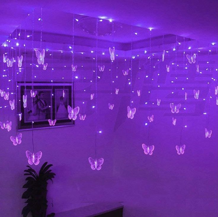 purple lights are hanging from the ceiling in a room