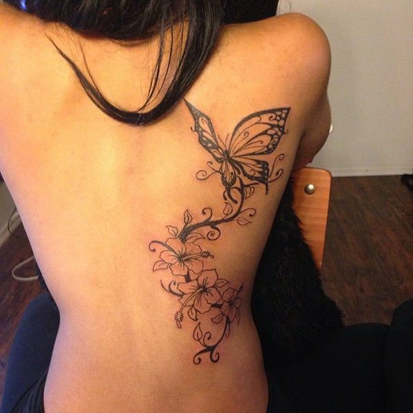 a woman with a butterfly tattoo on her back