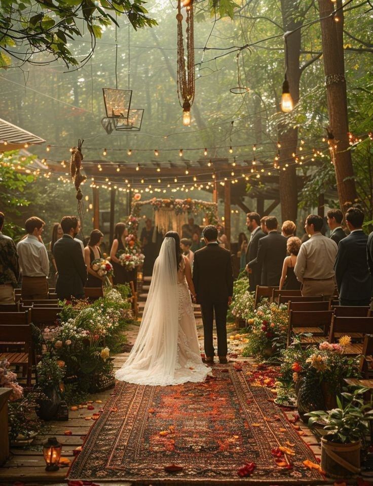 a bride and groom are walking down the aisle at their wedding ceremony in the woods