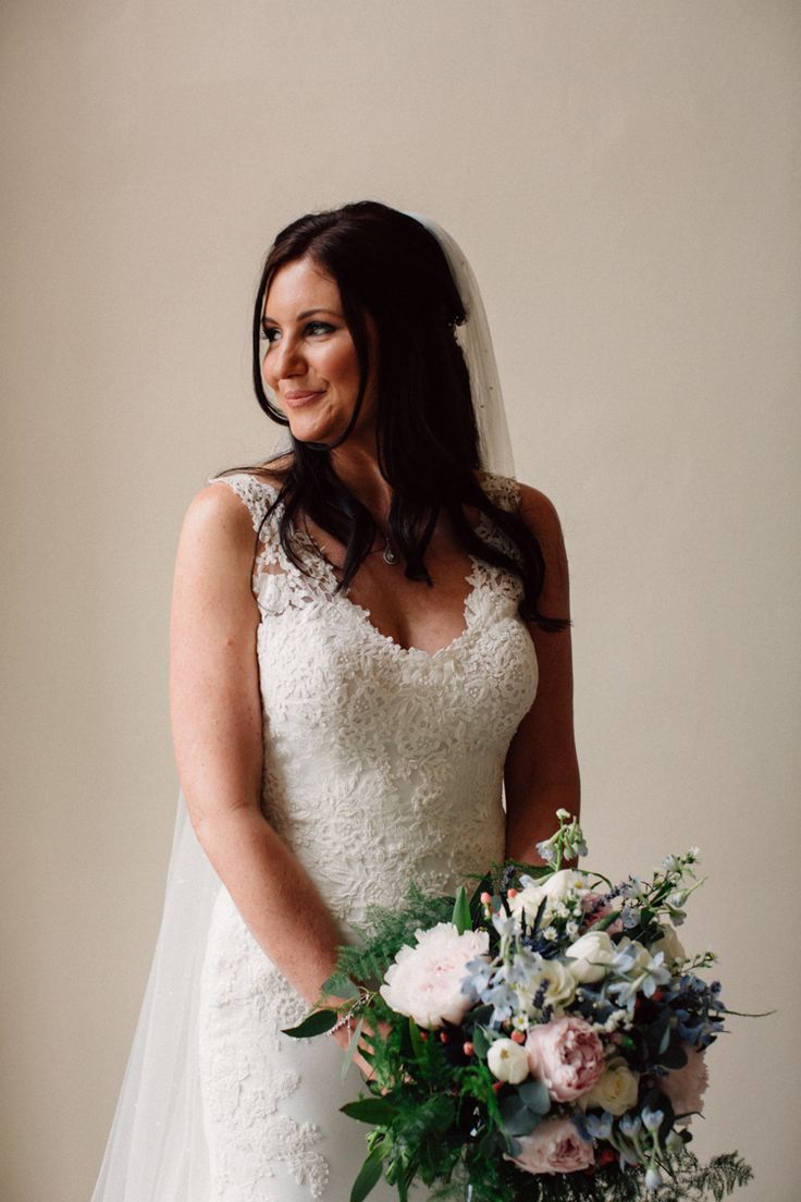 a woman in a wedding dress holding a bouquet