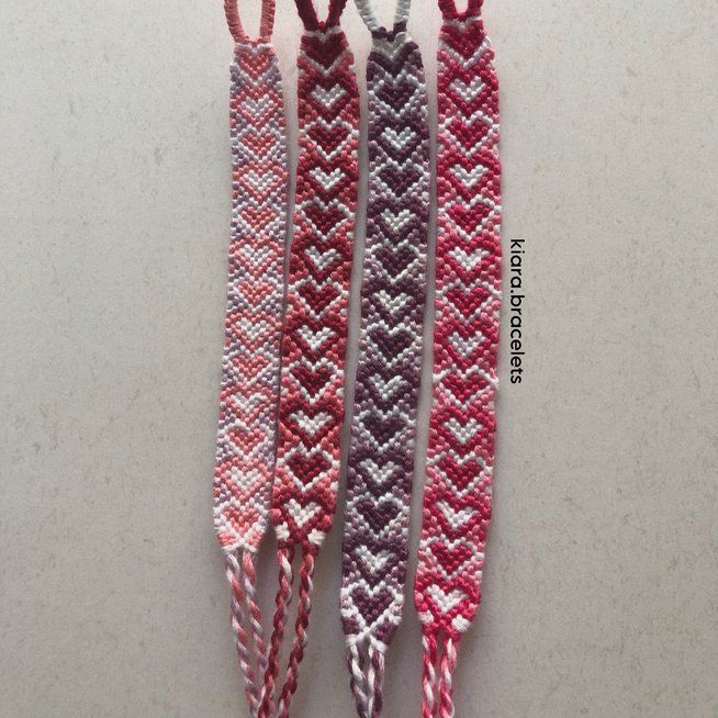 three crocheted bracelets with hearts on them hanging from the end of each strand