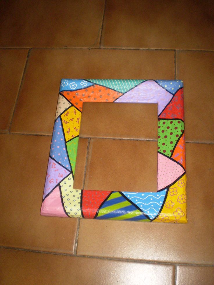 a small square shaped object sitting on top of a tiled floor next to a brown tile floor