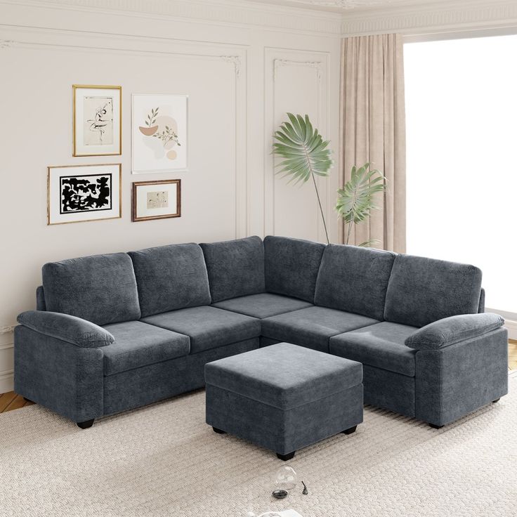 a living room with a sectional couch and ottoman