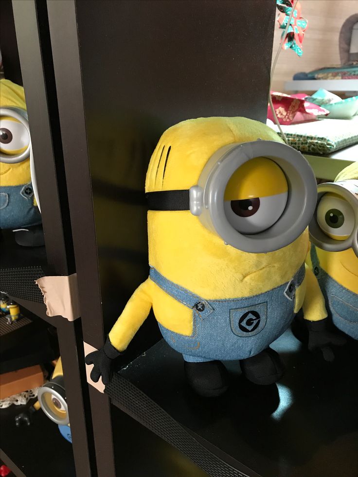 two yellow and black stuffed animals sitting on shelves