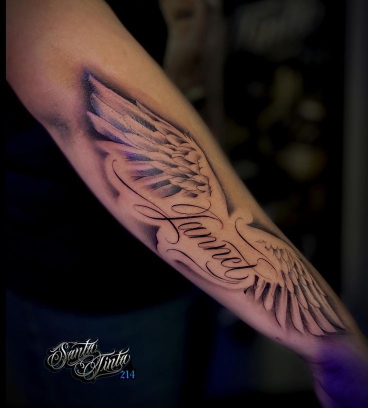 a man's arm with an angel wing and the words faith written on it